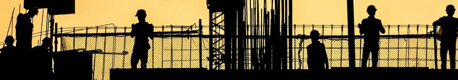 silhouette of people standing on tower crane during night time